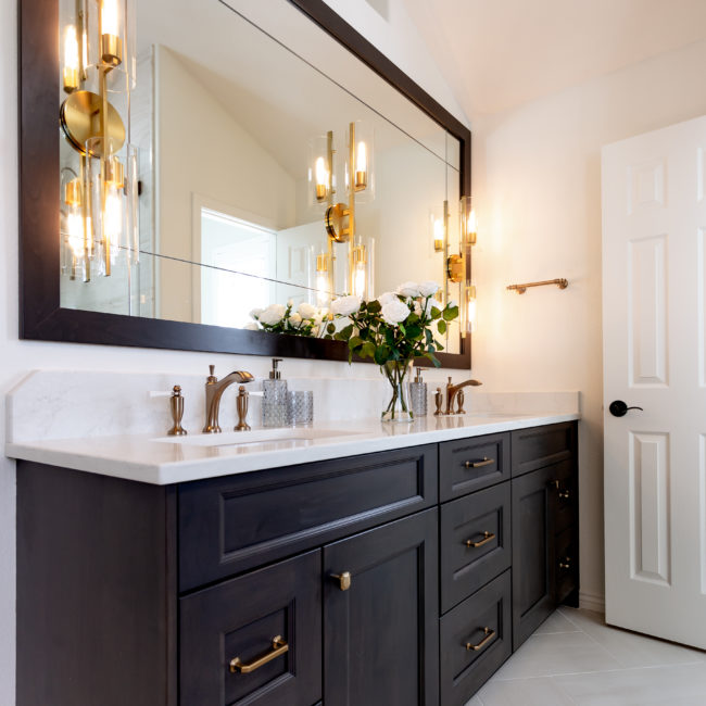 double sink vanity with large mirror and sconces